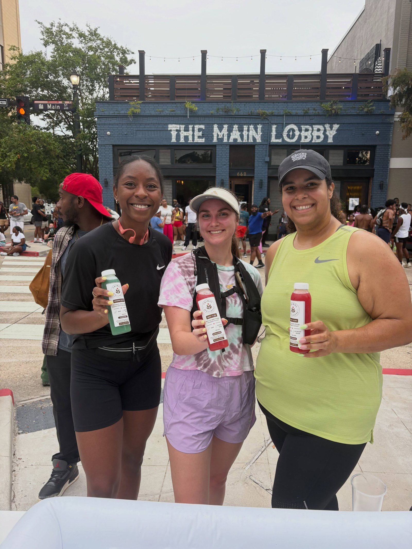 Community members holding Tribal Wellness juices