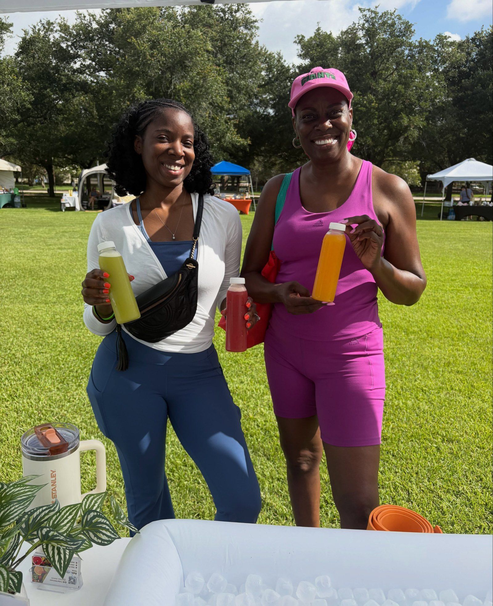 Two customers enjoying Tribal Wellness juice at a park event